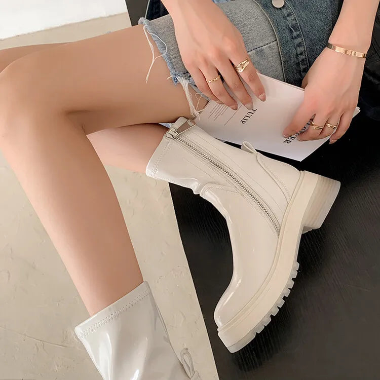 Side view of a young lady wearing HighSta White designer ankle boots for women, the HS platform designer booties.