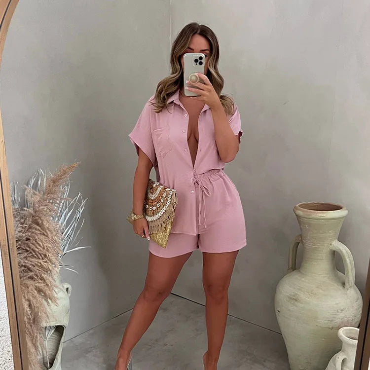 A young women wearing highsta button up shirt with shorts set ligh pink sets.