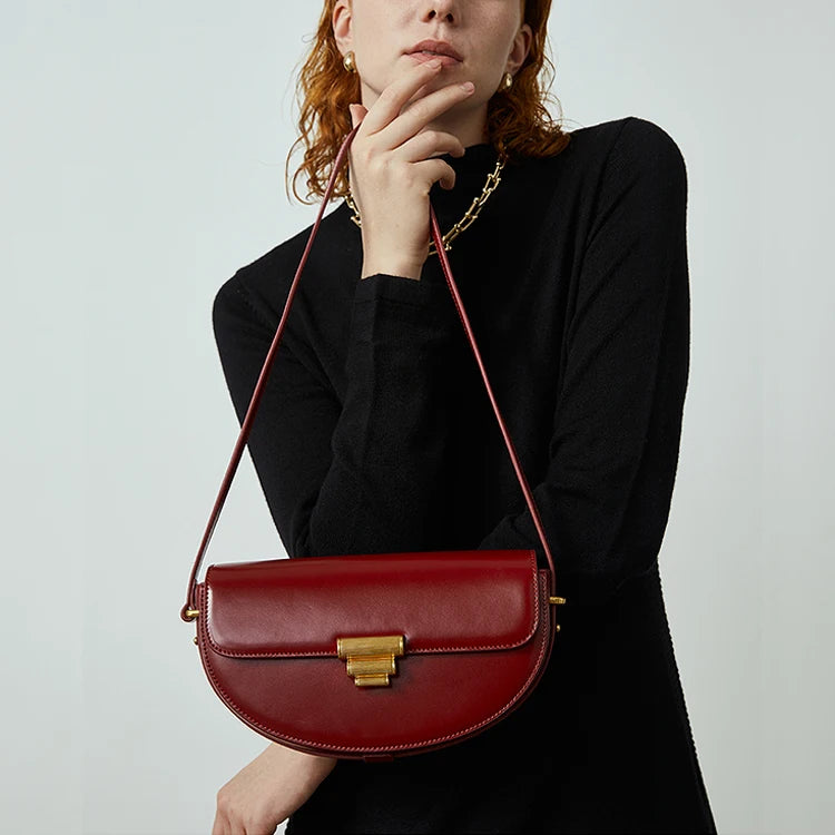 Young women carrying highsta hs one of the best designer shoulder handbags, Aure Saddle Handbag.