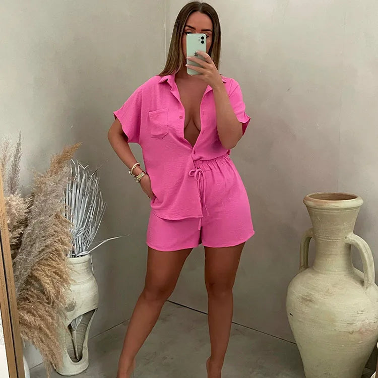 A young women wearing highsta button up shirt with shorts set pink.